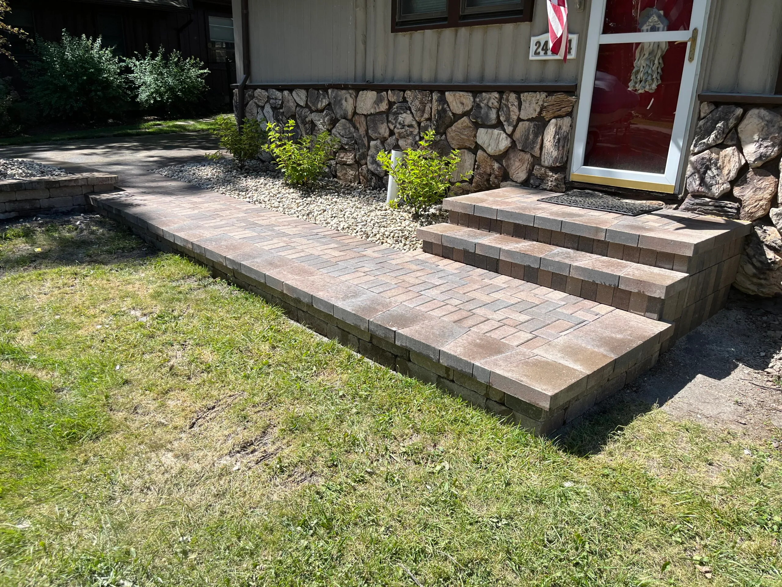 Front entry paver steps with stone facade