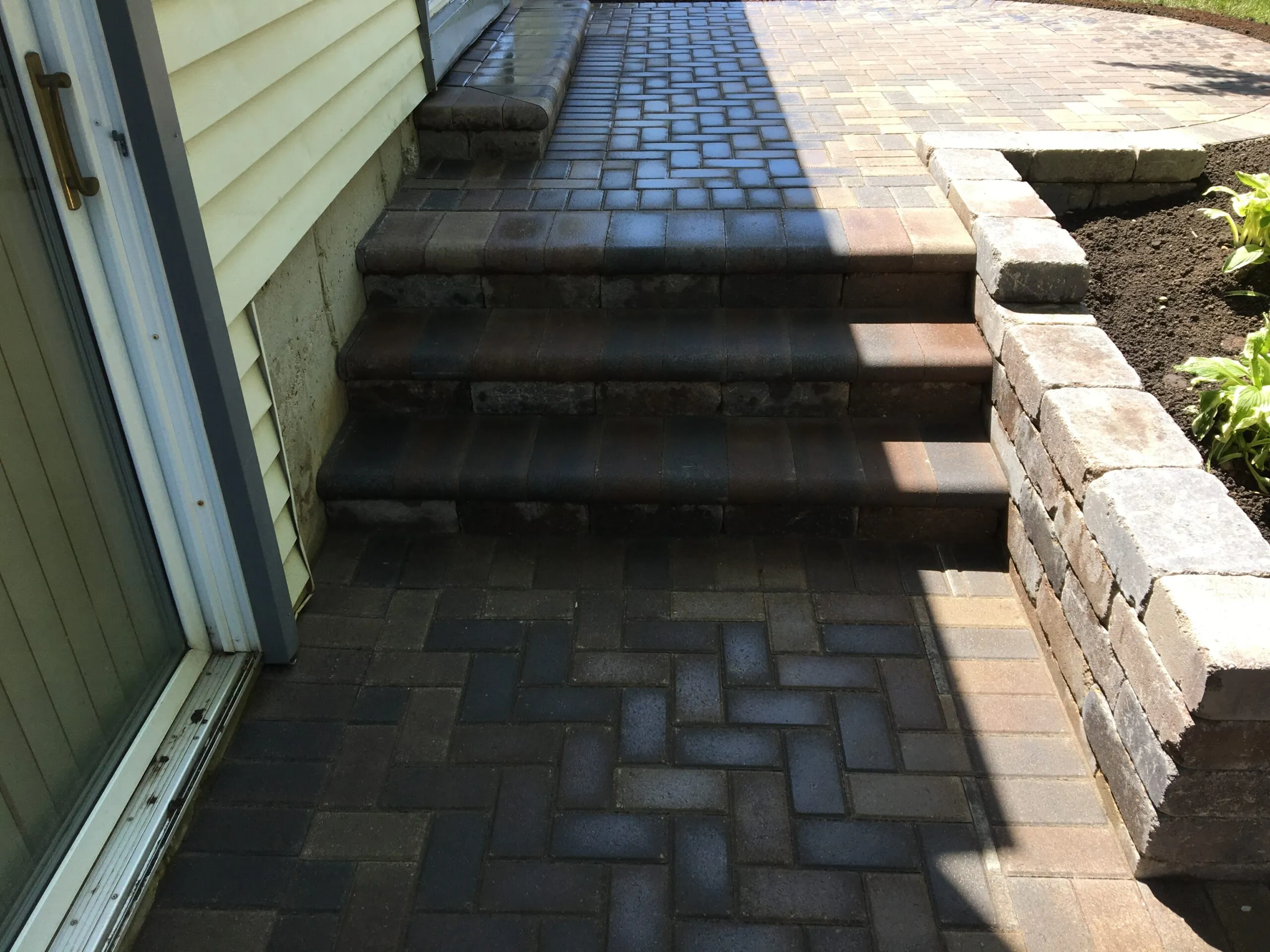 Herringbone paver steps with retaining wall