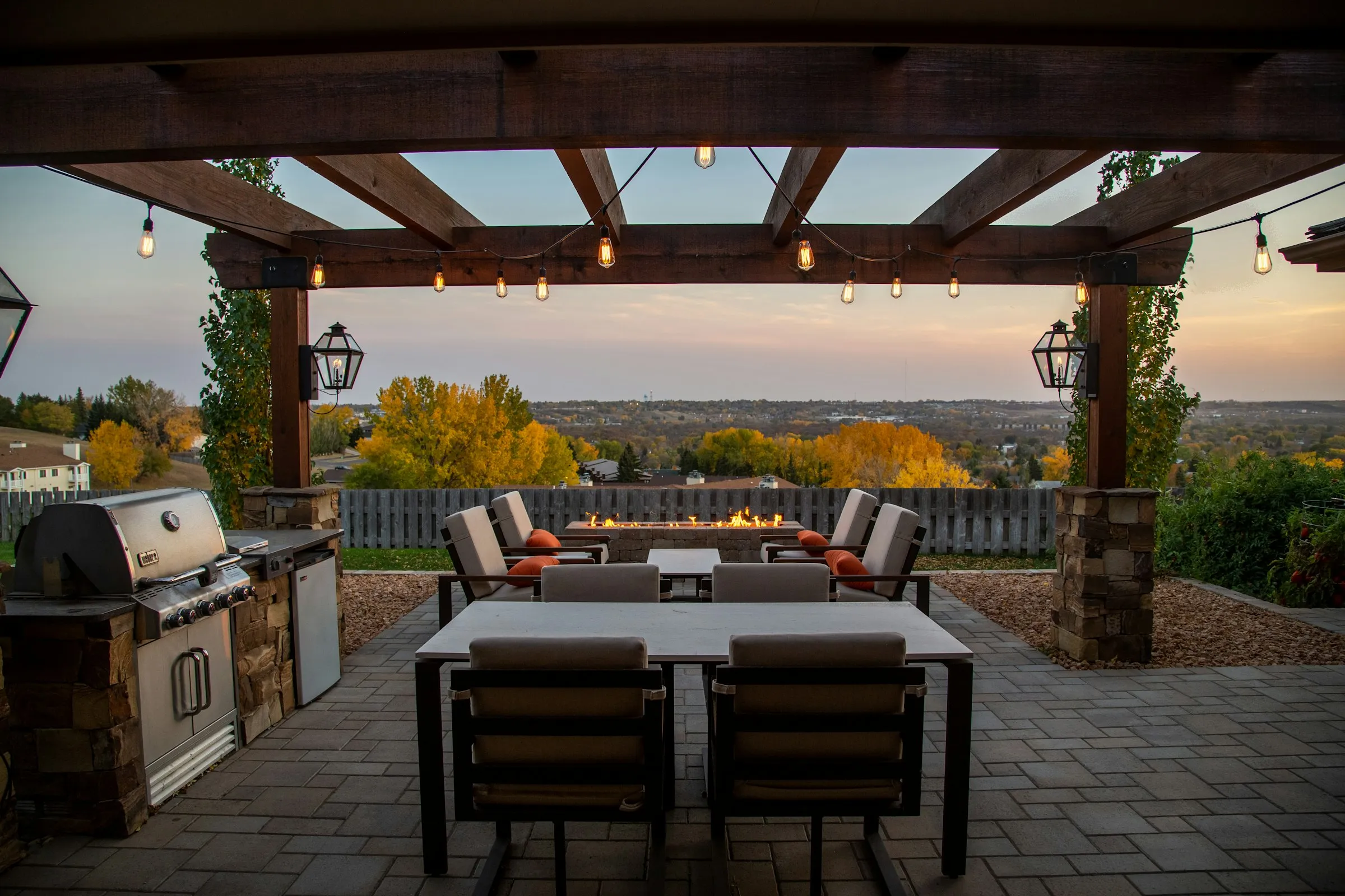 Covered outdoor kitchen and dining area at sunset