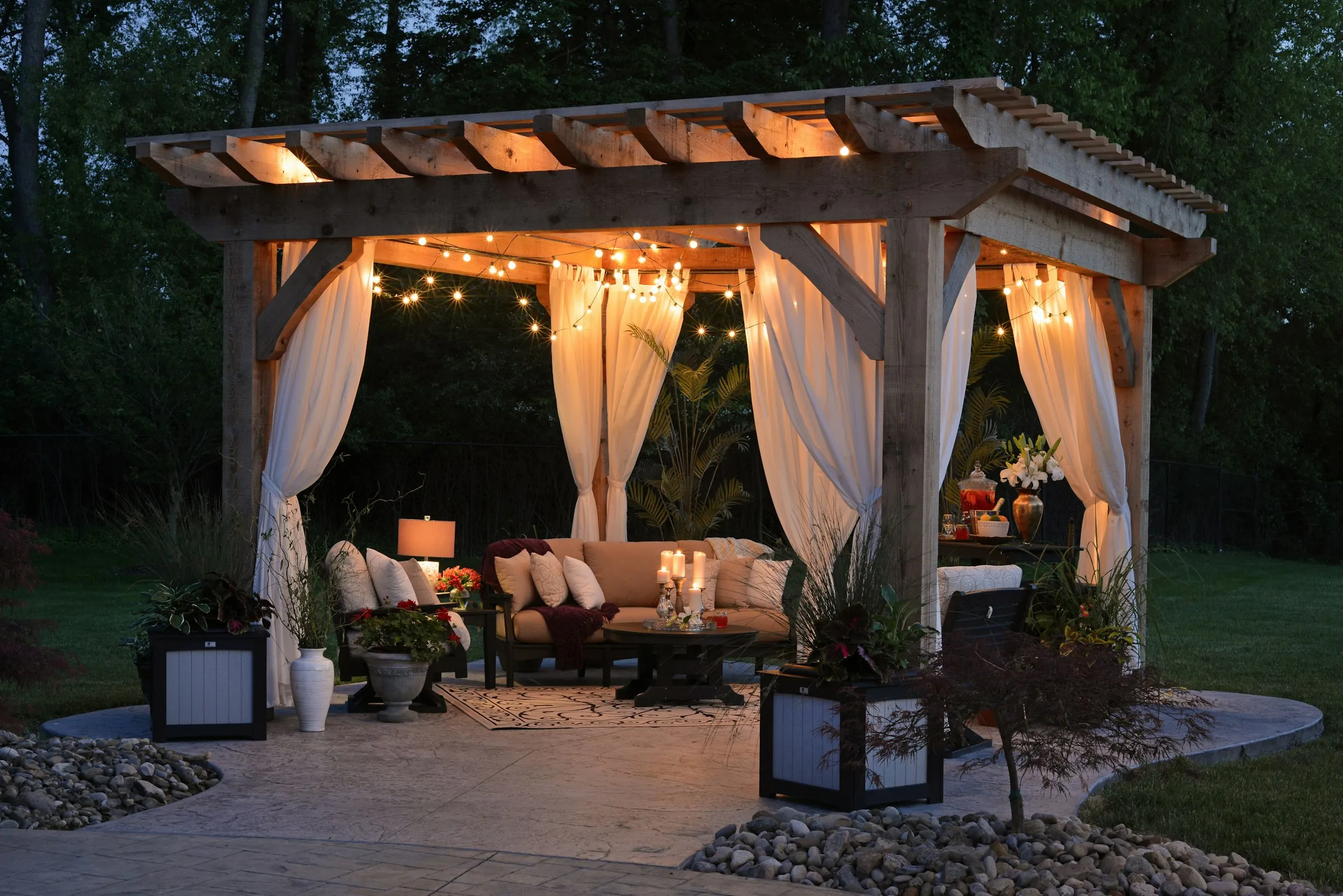 Backyard pergola with warm lights at dusk